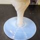 Vintage white opaline soliflore vase with blue reflections and twisted foot.
