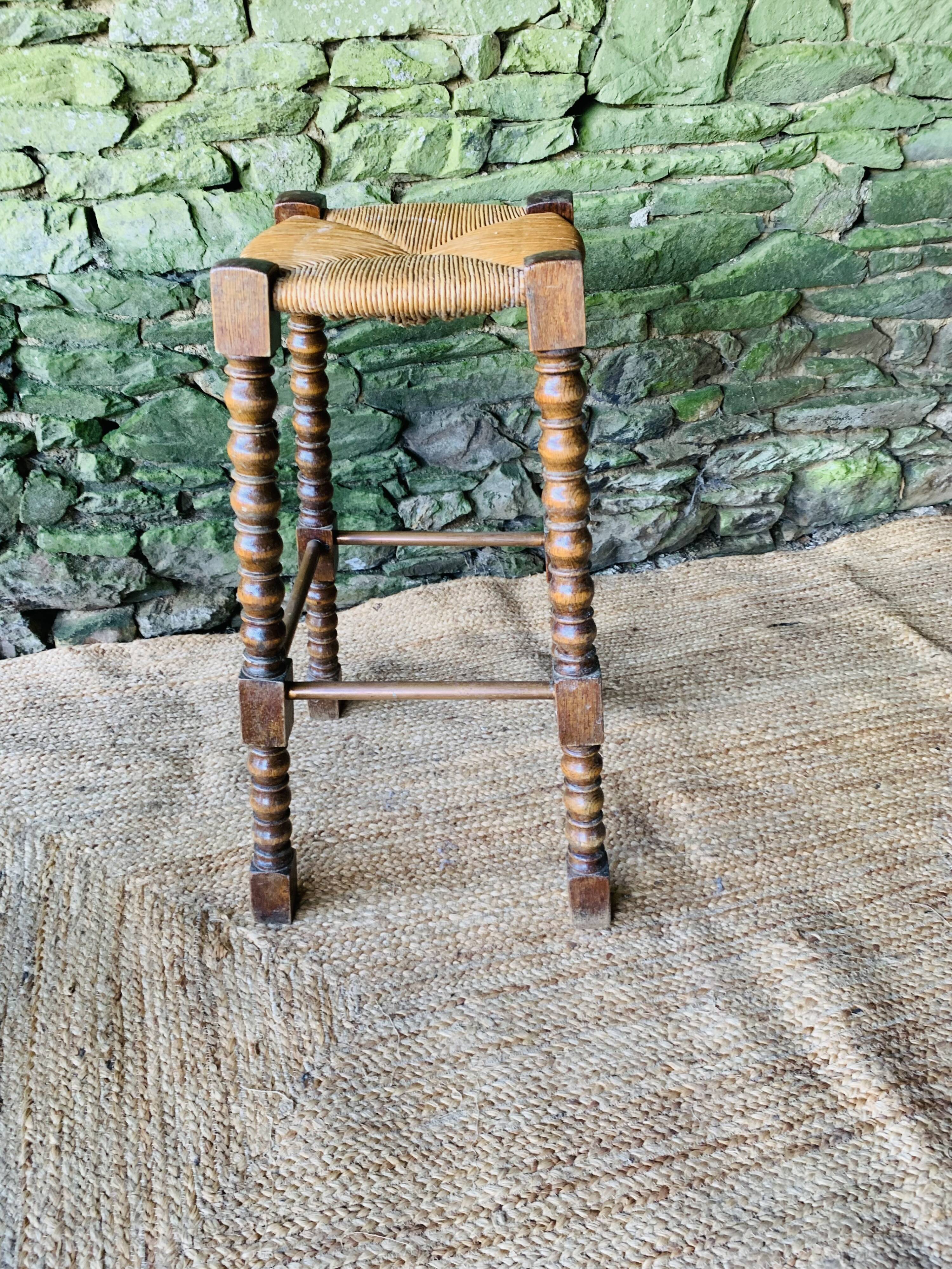 High stool in turned wood
