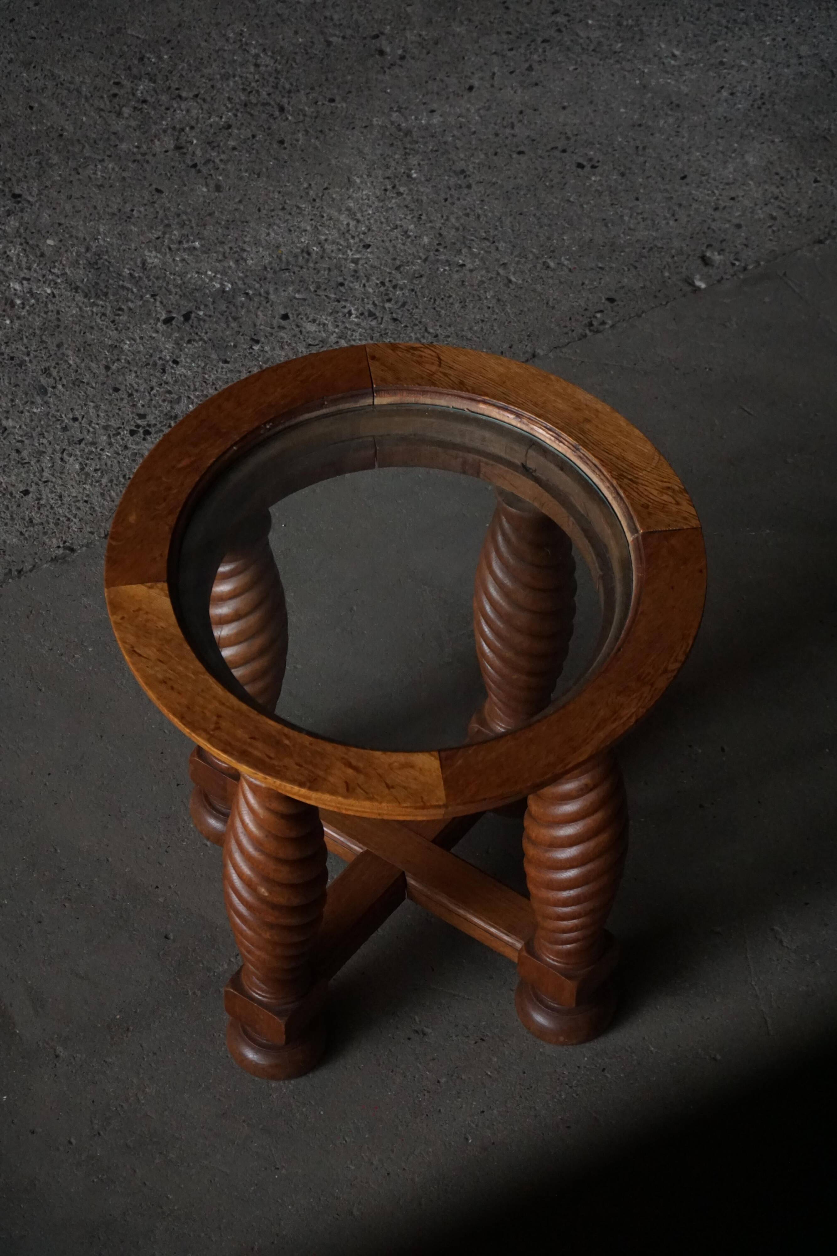 Modern Danish mid-century table, made of oak with spiral turned legs and a glass top, 1950s.