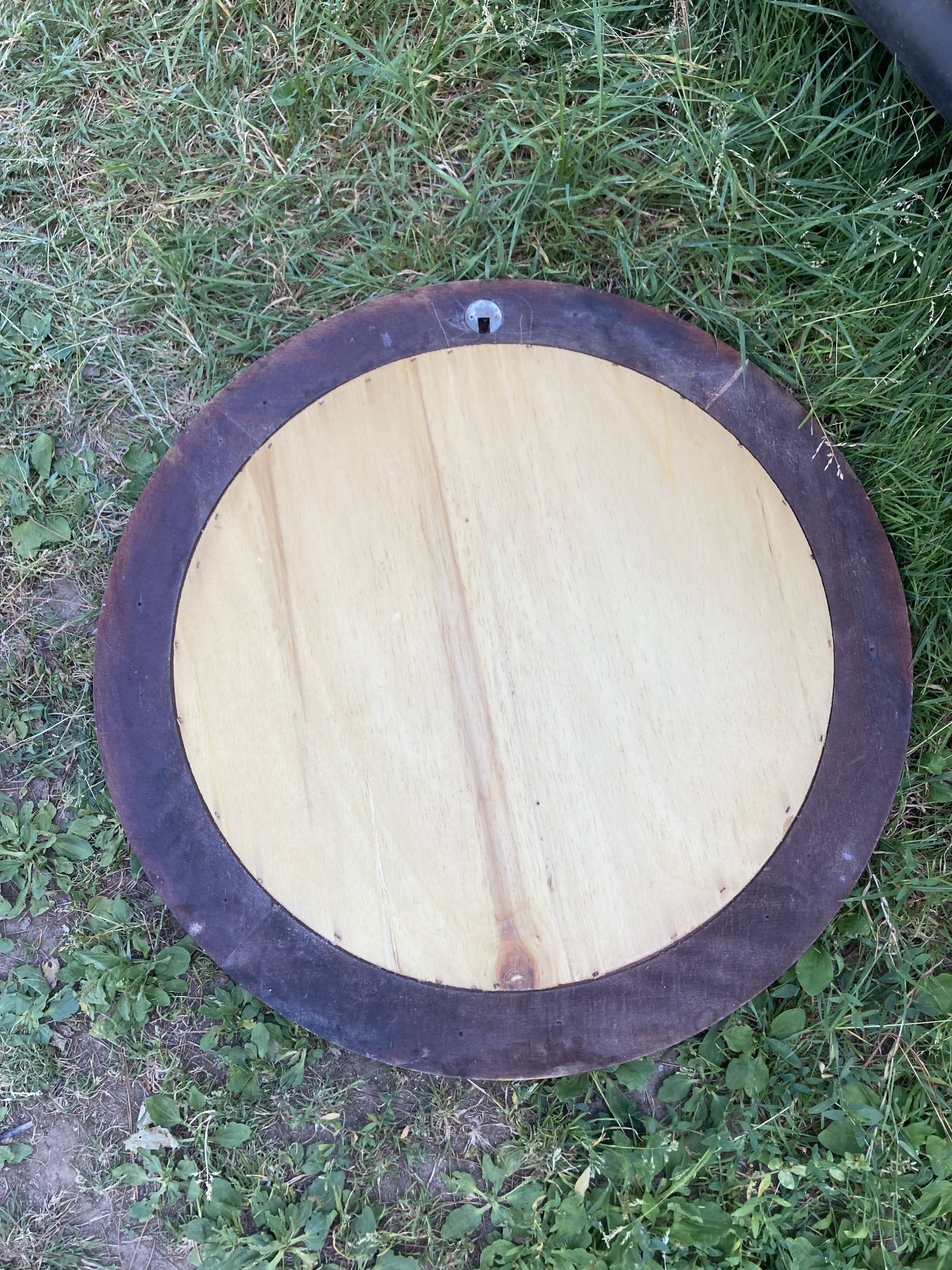 Round varnished wooden mirror