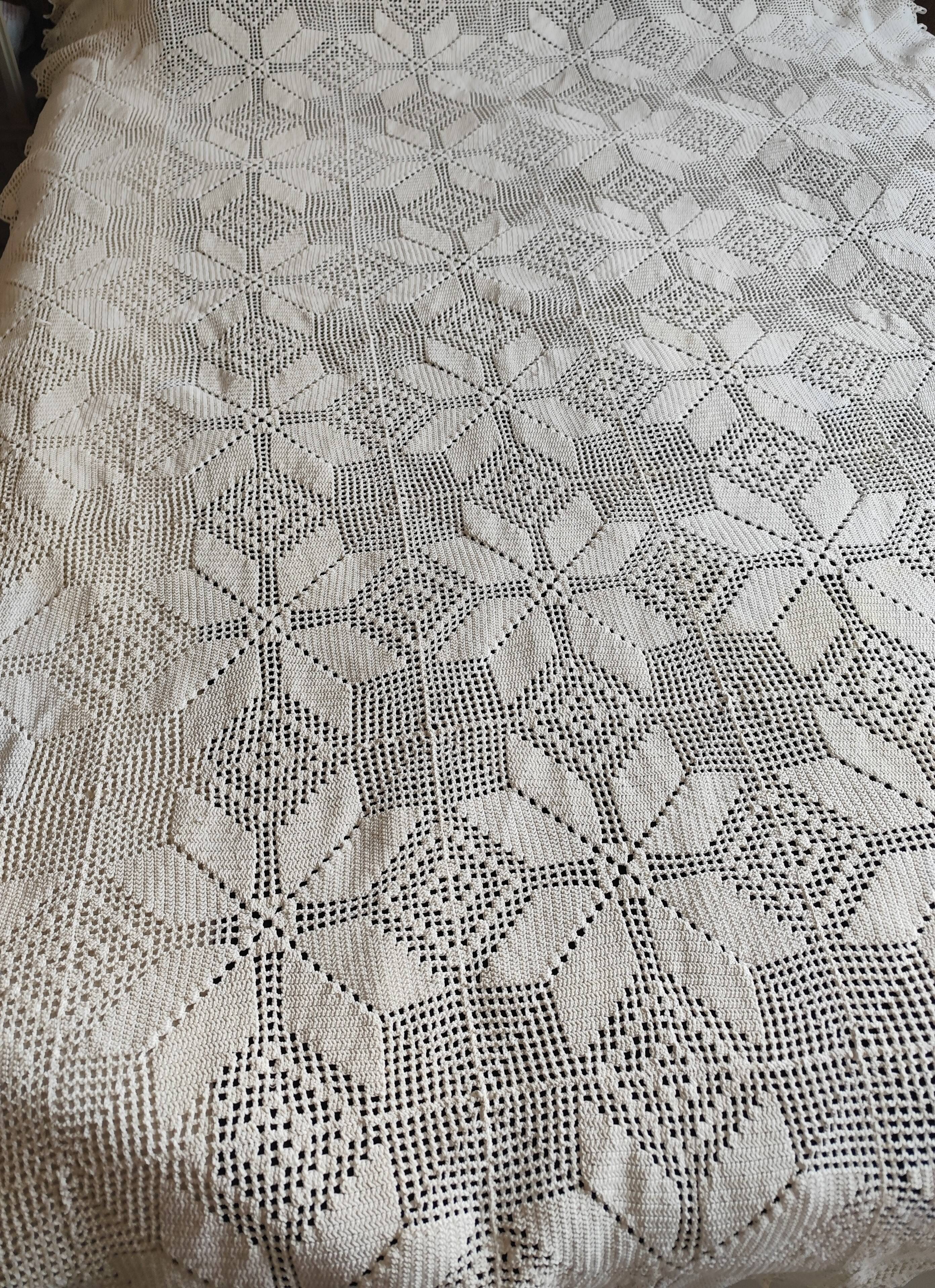 White cotton bedspread, crocheted sofa throw with star patterns