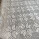 White cotton bedspread, crocheted sofa throw with star patterns