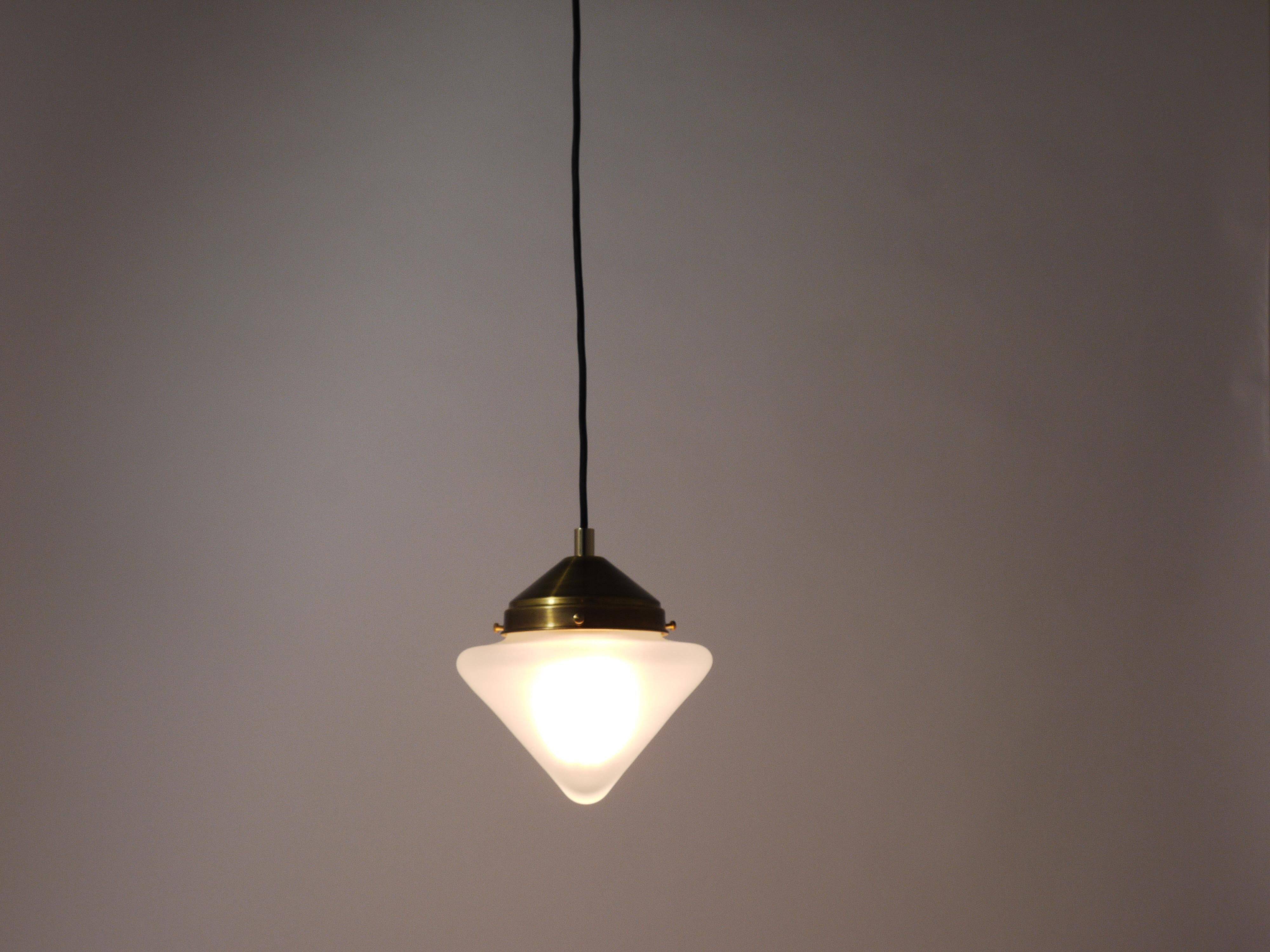 Up to 7 Art Deco brass pendant lights with conical glass shades, Vienna 1930s.