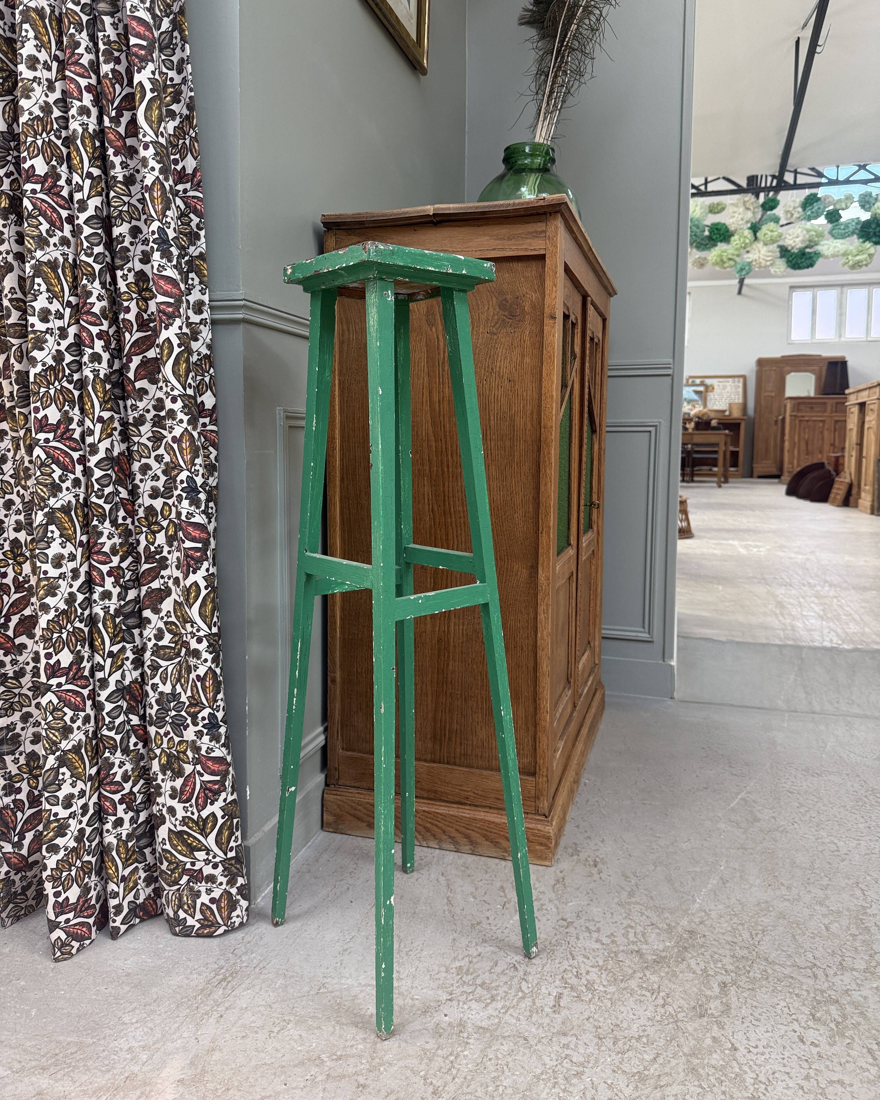 Vintage wooden stool with green patina.