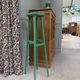 Vintage wooden stool with green patina.