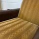 Vintage brown / ochre armchair / a chair on wheels