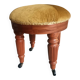 Upholstered stool on casters