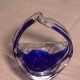 Ashtray in transparent and blue blown glass with a design shape