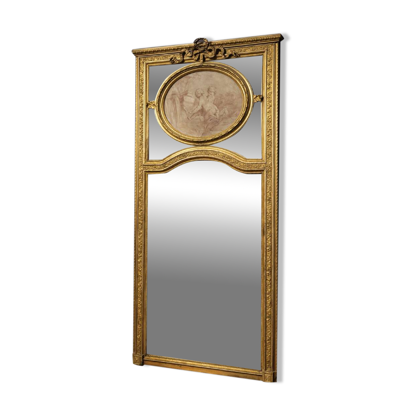 Very large mirror with mouldings, richly carved and gilded, in the Louis XVI style.
