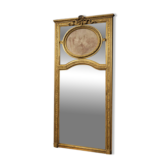 Very large mirror with mouldings, richly carved and gilded, in the Louis XVI style.