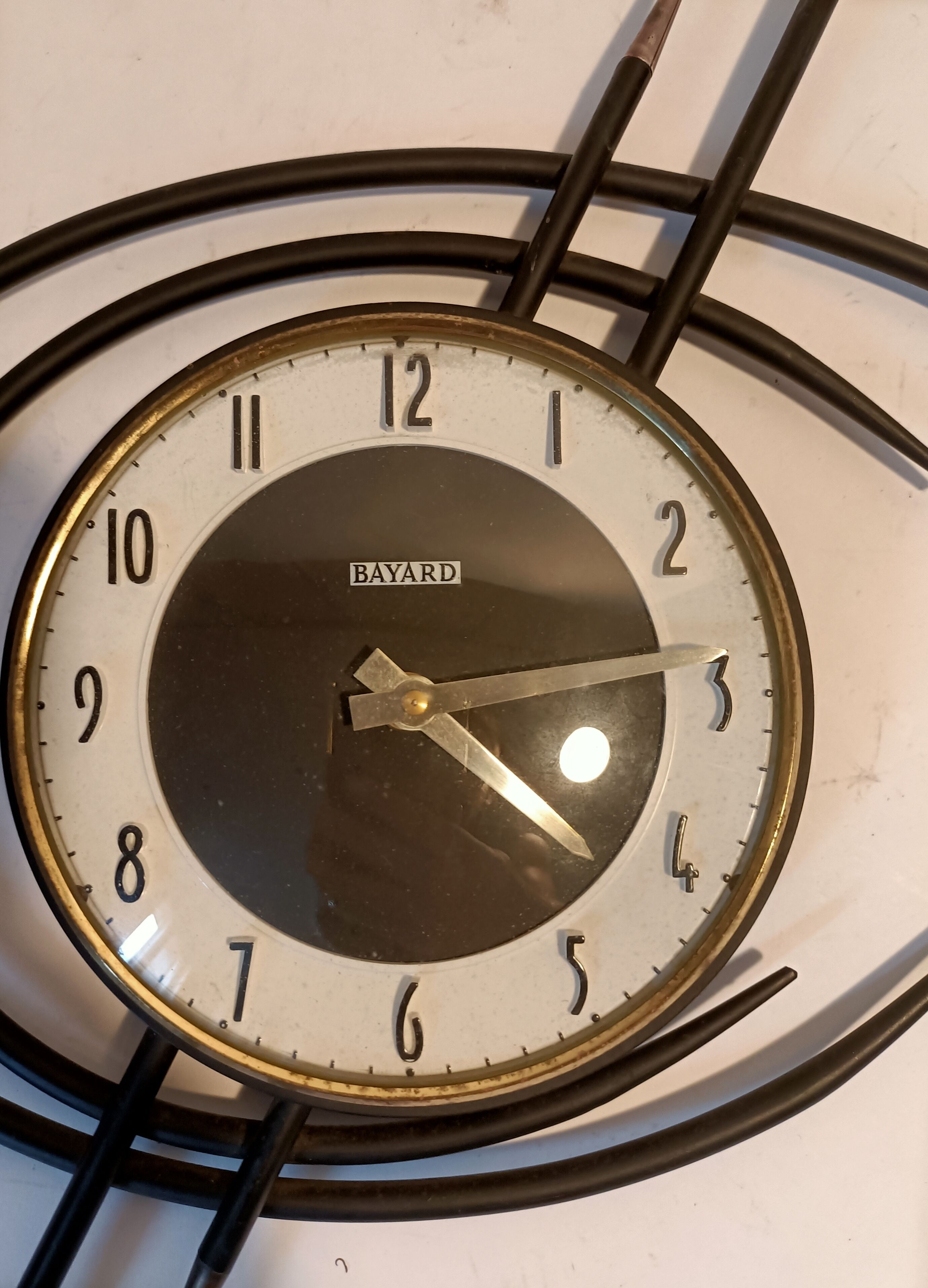 Bayard ortf wall clock in black metal and gilded brass. 1960