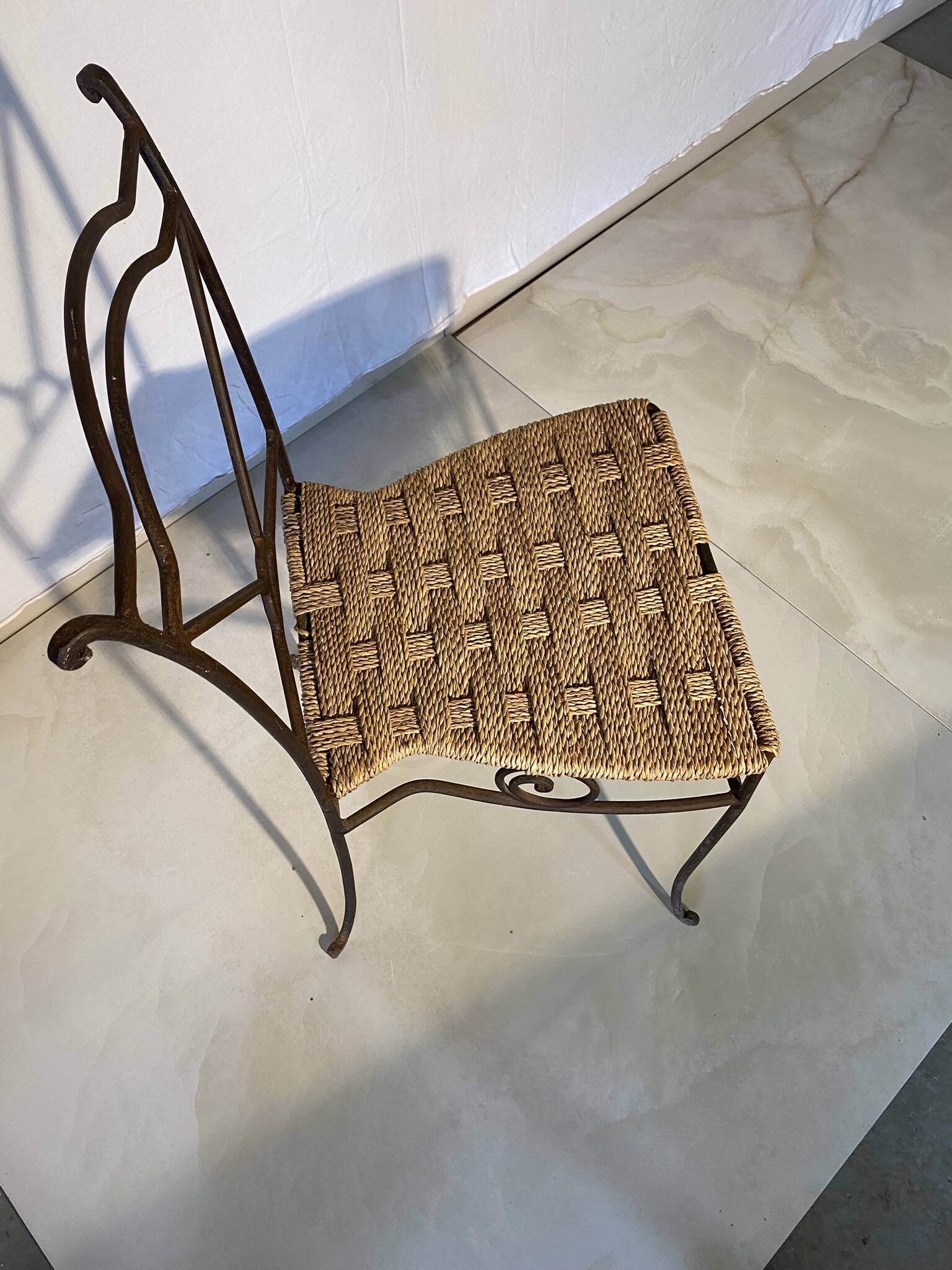 Wrought iron chair with woven seat