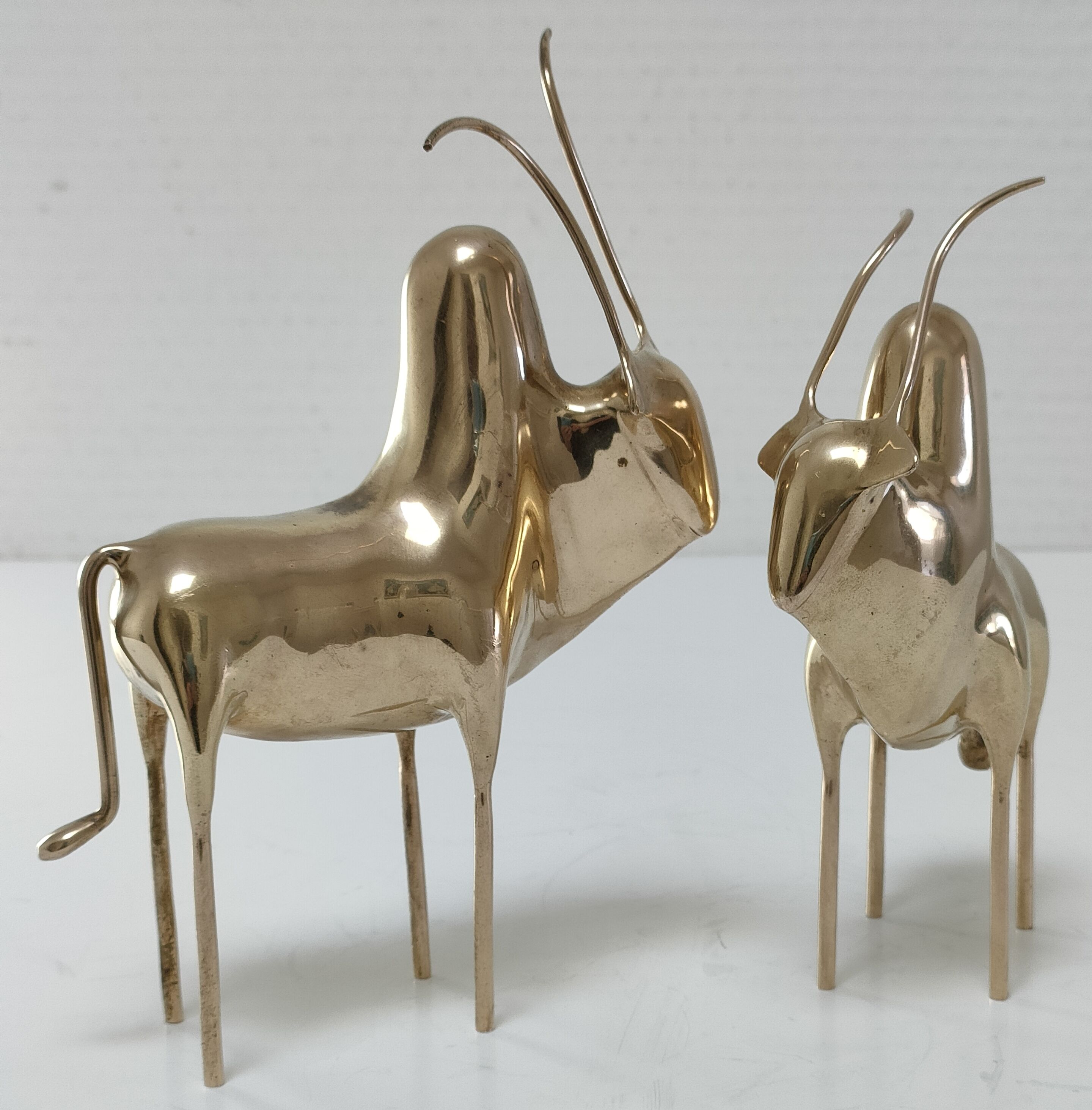 Two stylized zebu with long vintage brass horns