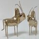 Two stylized zebu with long vintage brass horns