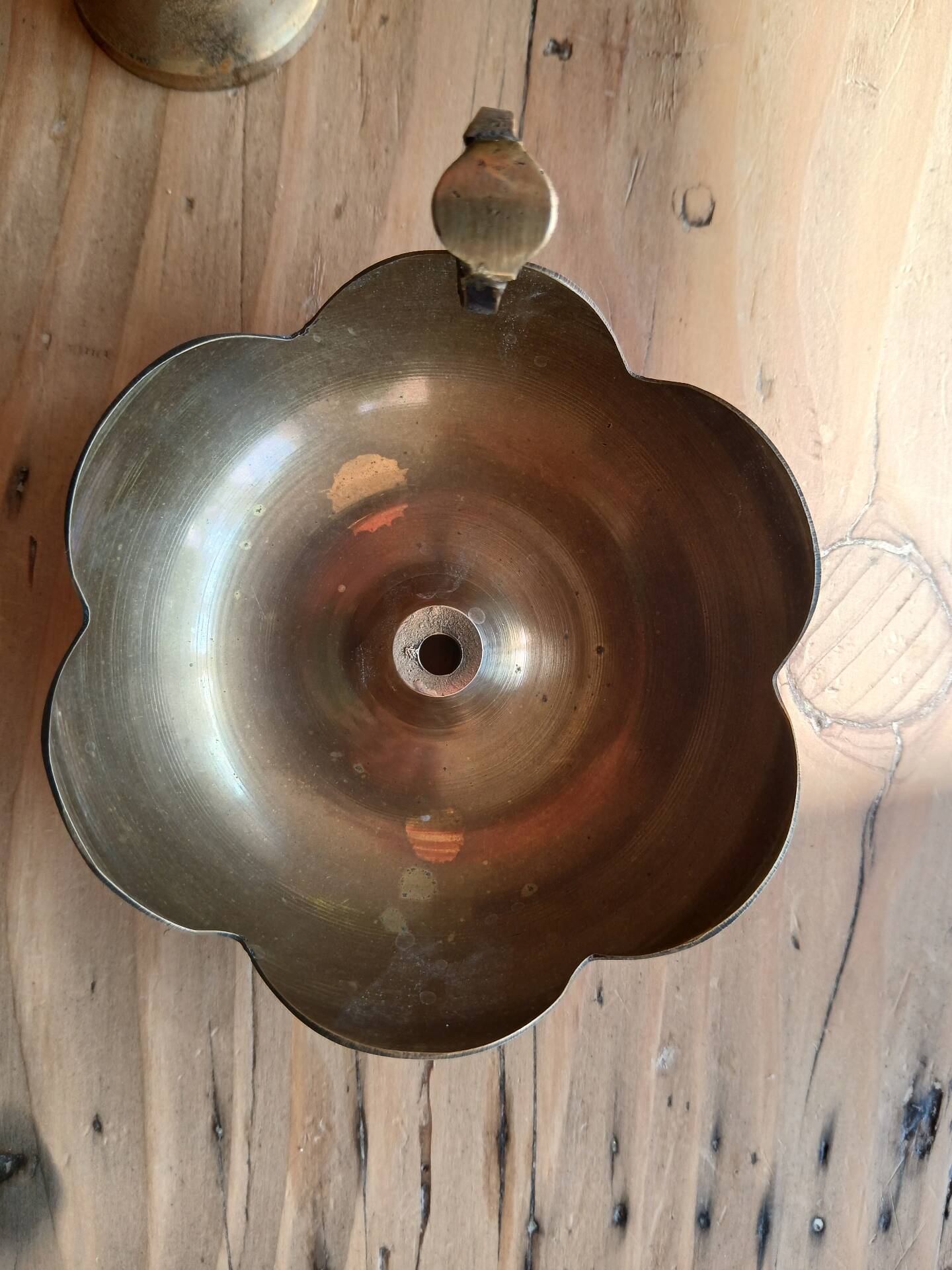 Brass candle holder in the shape of a flower.