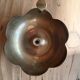 Brass candle holder in the shape of a flower.