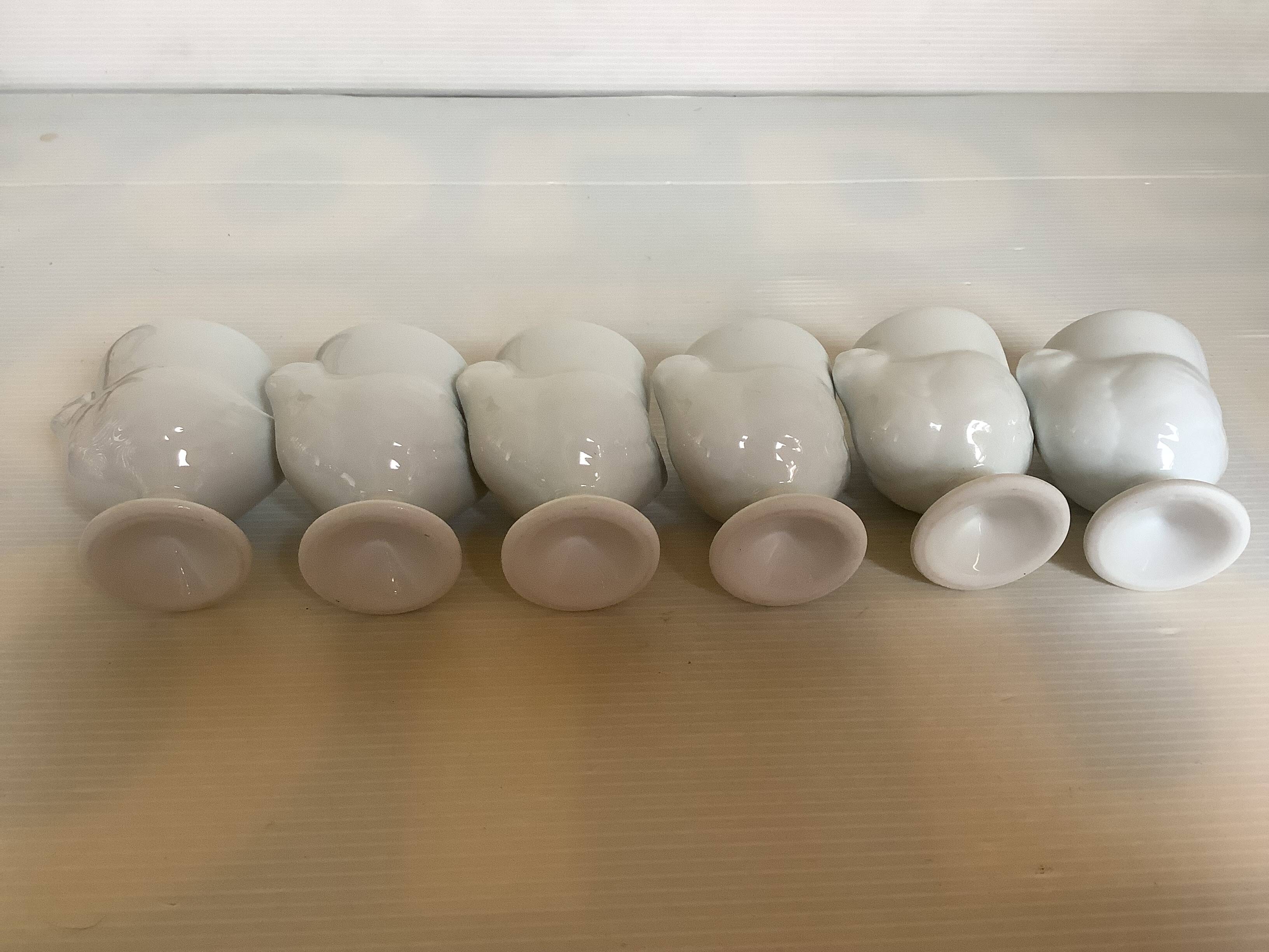 Six white hen egg cups