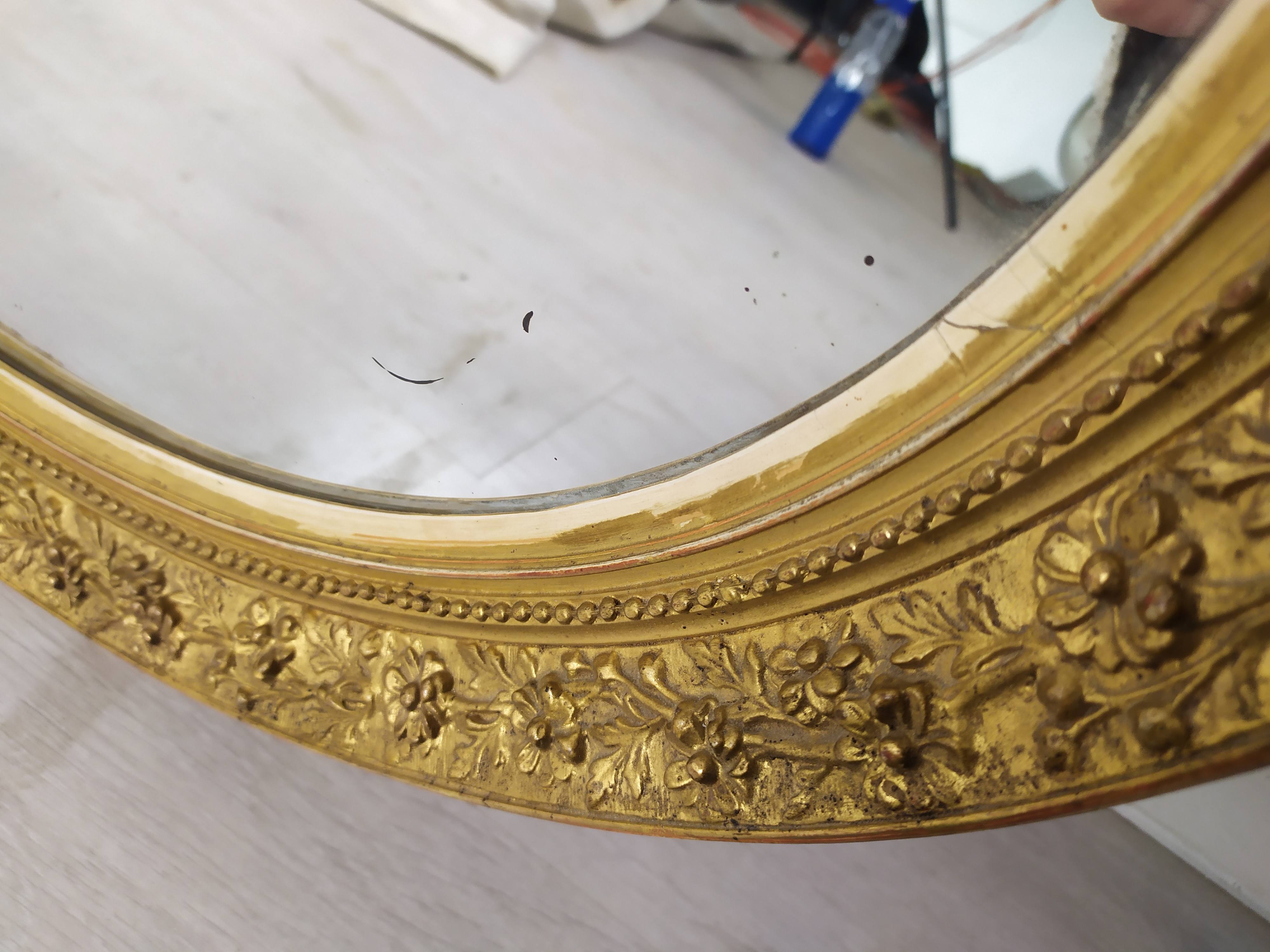 Golden oval mirror
