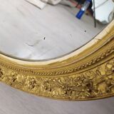 Golden oval mirror