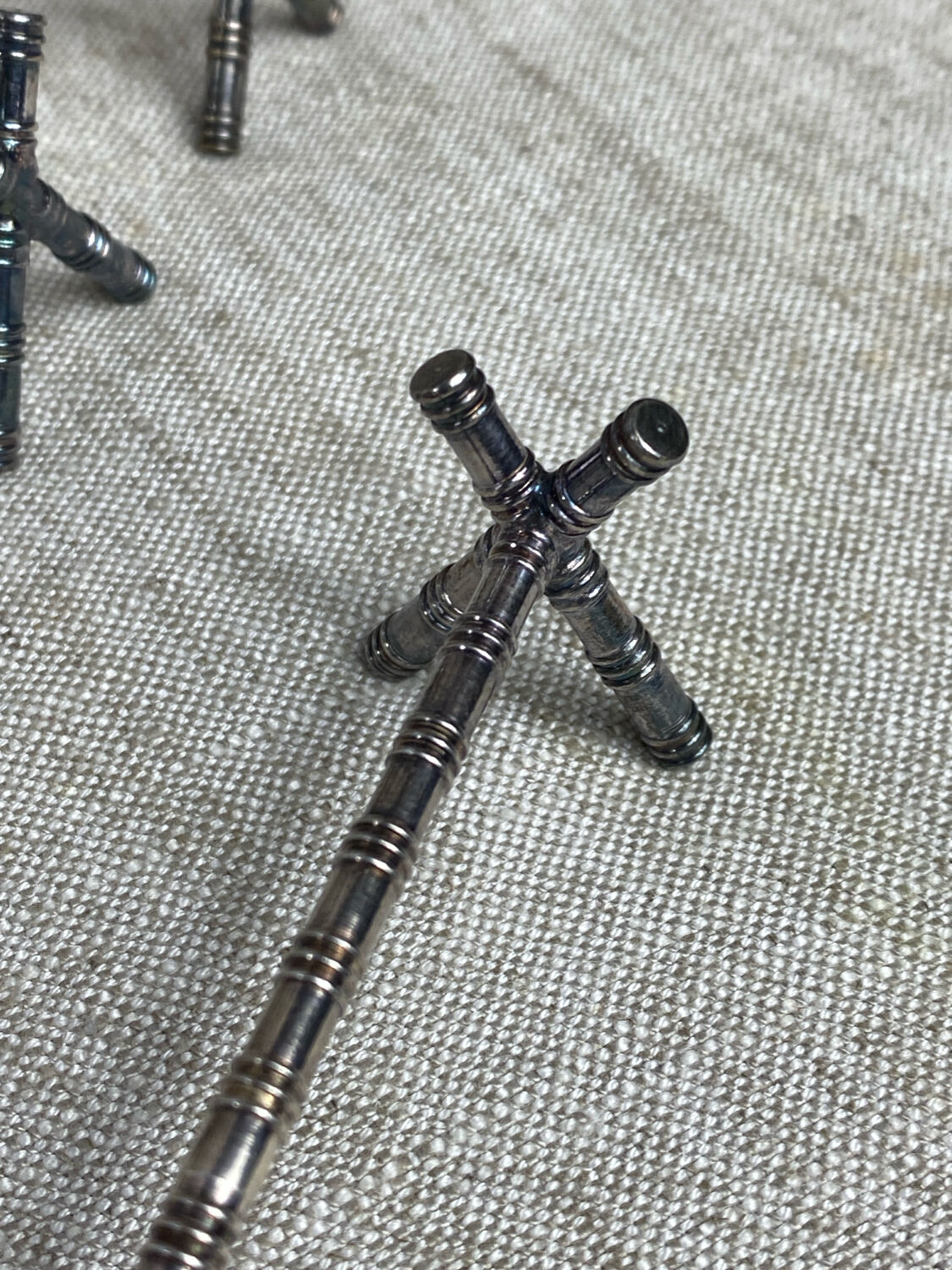 Six bamboo-patterned metal silver-plated knife rests.