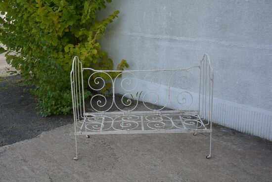 Old white wrought iron child bed