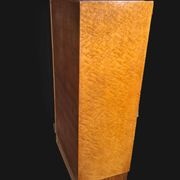 Art Deco cabinet in speckled maple veneer with asymmetrical shelves.