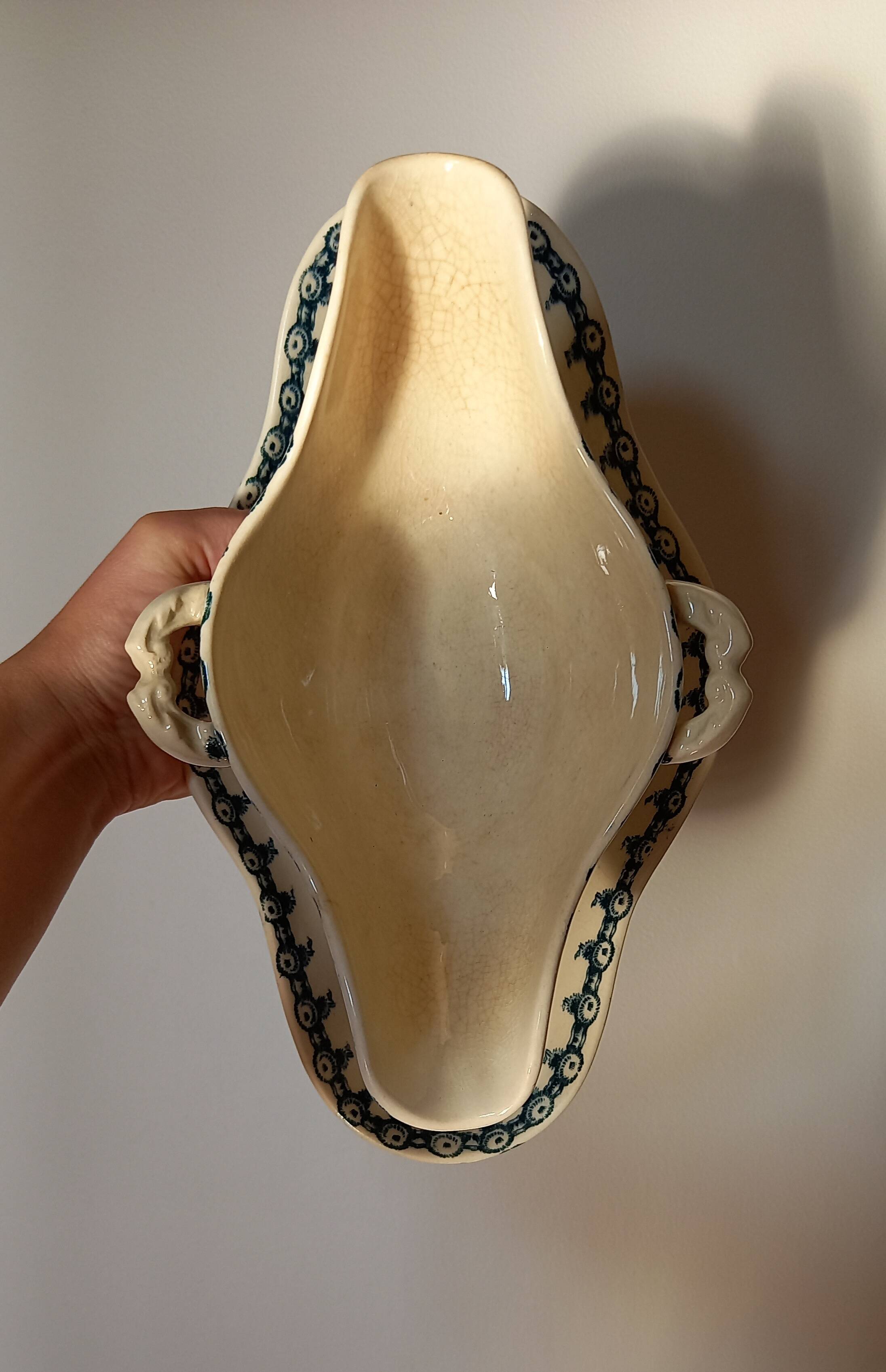 Old gravy boat on frame in terre de fer earthenware by gien, “chardons” model in blue-green