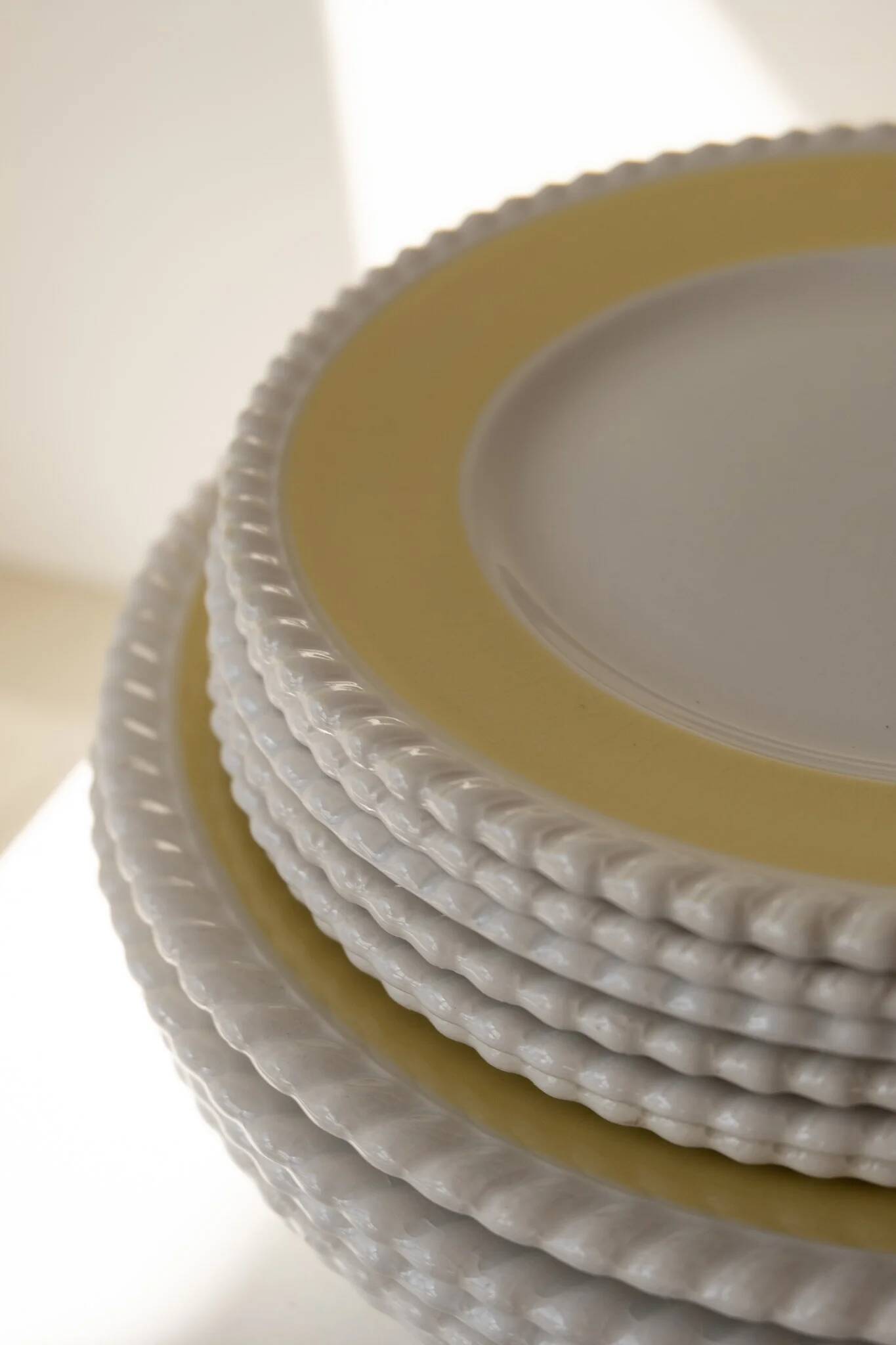 Vintage yellow butter ceramic dinnerware set with swirl border.