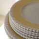 Vintage yellow butter ceramic dinnerware set with swirl border.