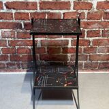 Black metal server and earthenware tiles with geometric patterns