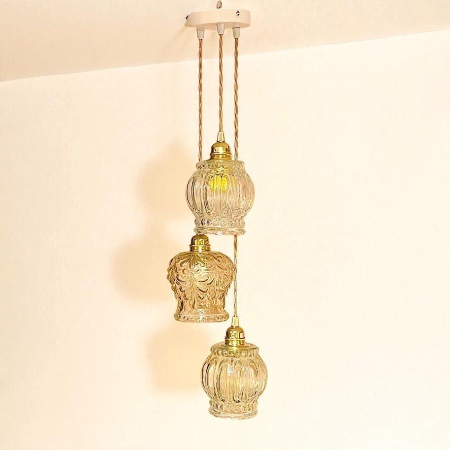 Cascade pendant light with 3 molded glass globes in vintage arabesque amber glass