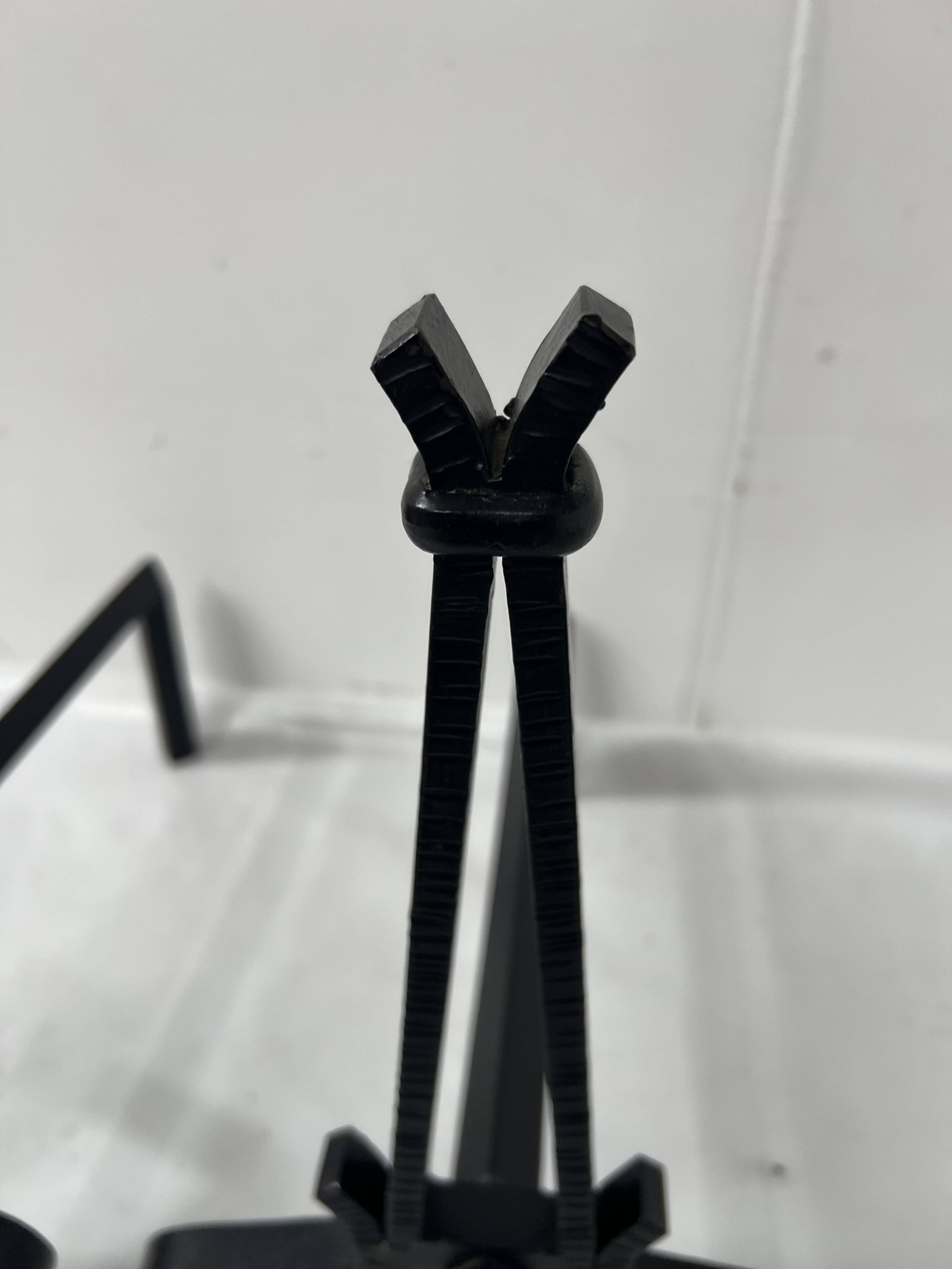 Pair of wrought and hammered iron bedside tables, 20th century