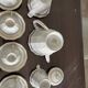 a vintage coffee or tea set in white porcelain with patterns and