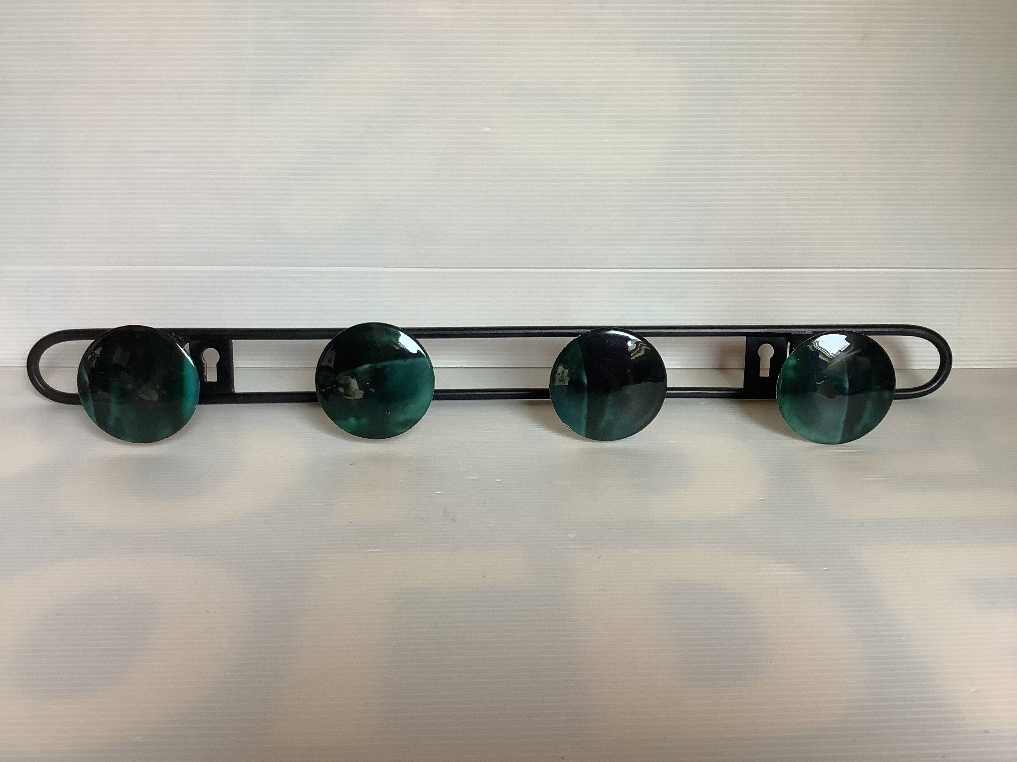 Green black metal coat rack with four hooks