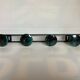 Green black metal coat rack with four hooks
