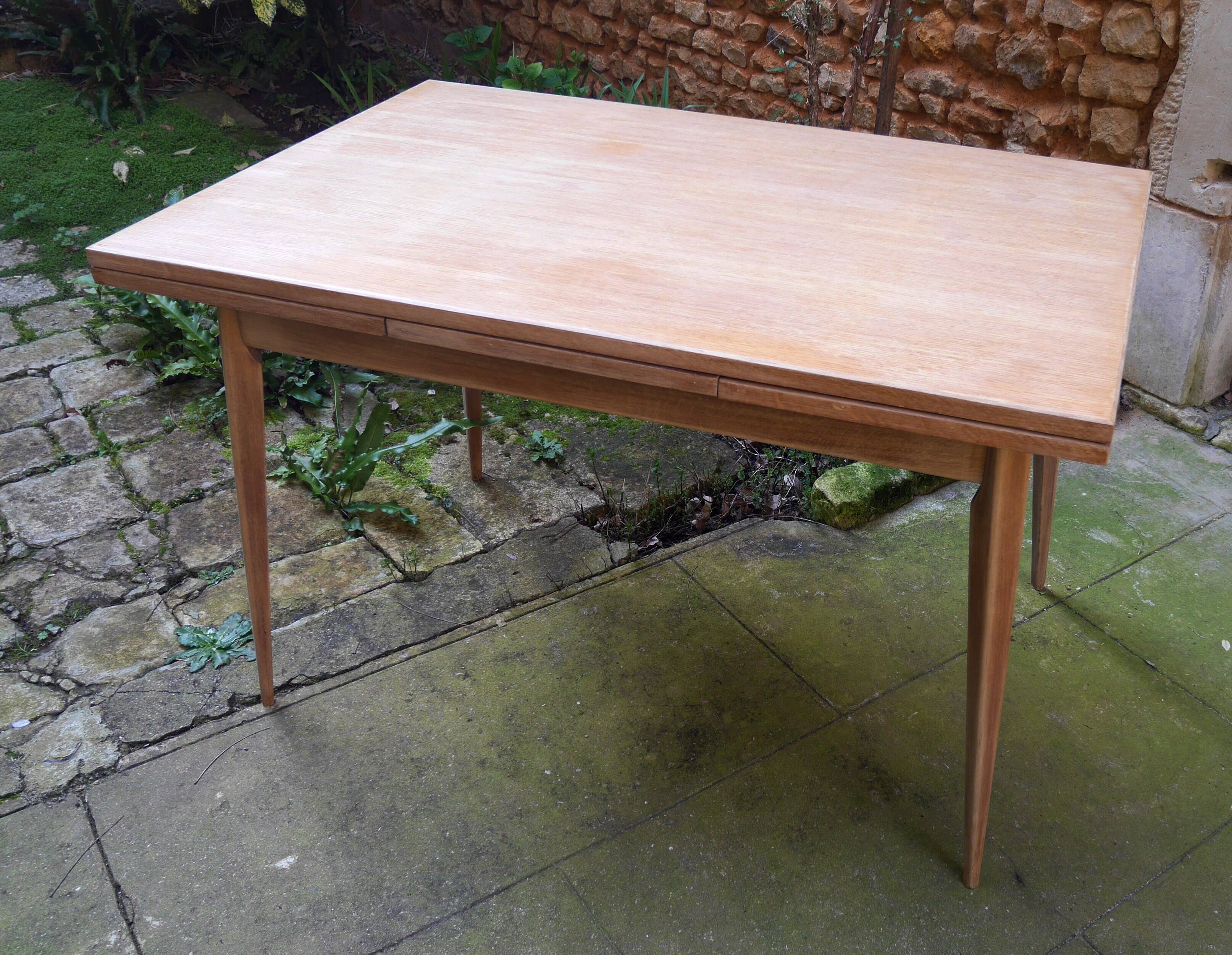 wooden dining table with compass legs and extensions