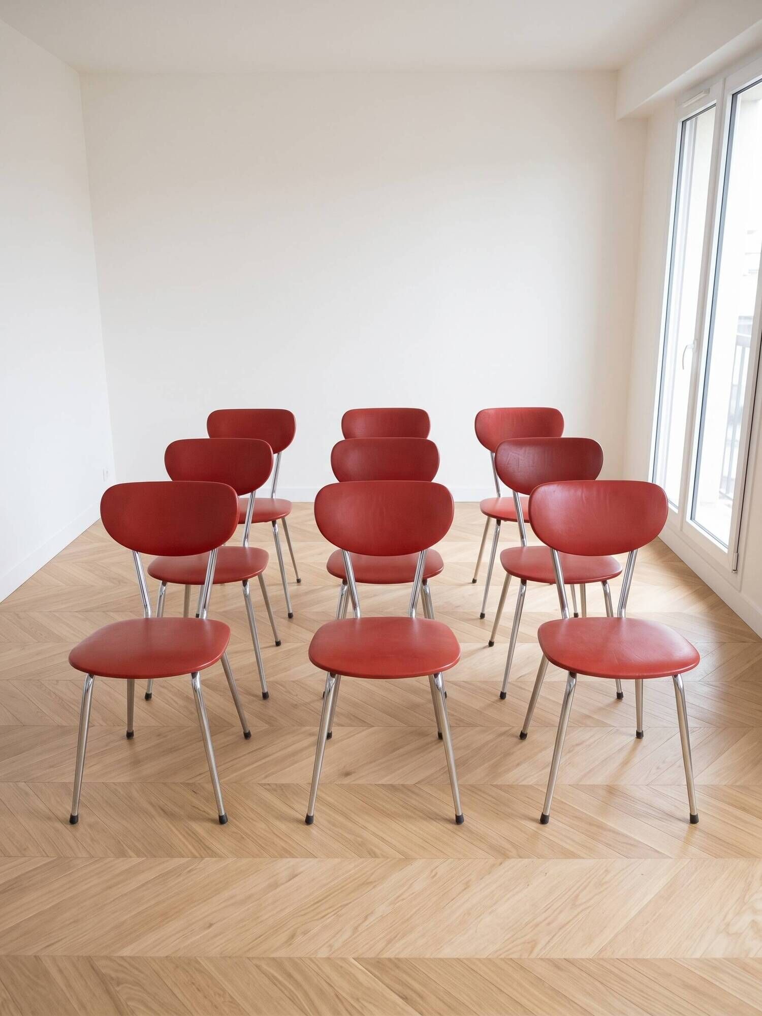 Set of 9 vintage retro chairs in red faux leather.