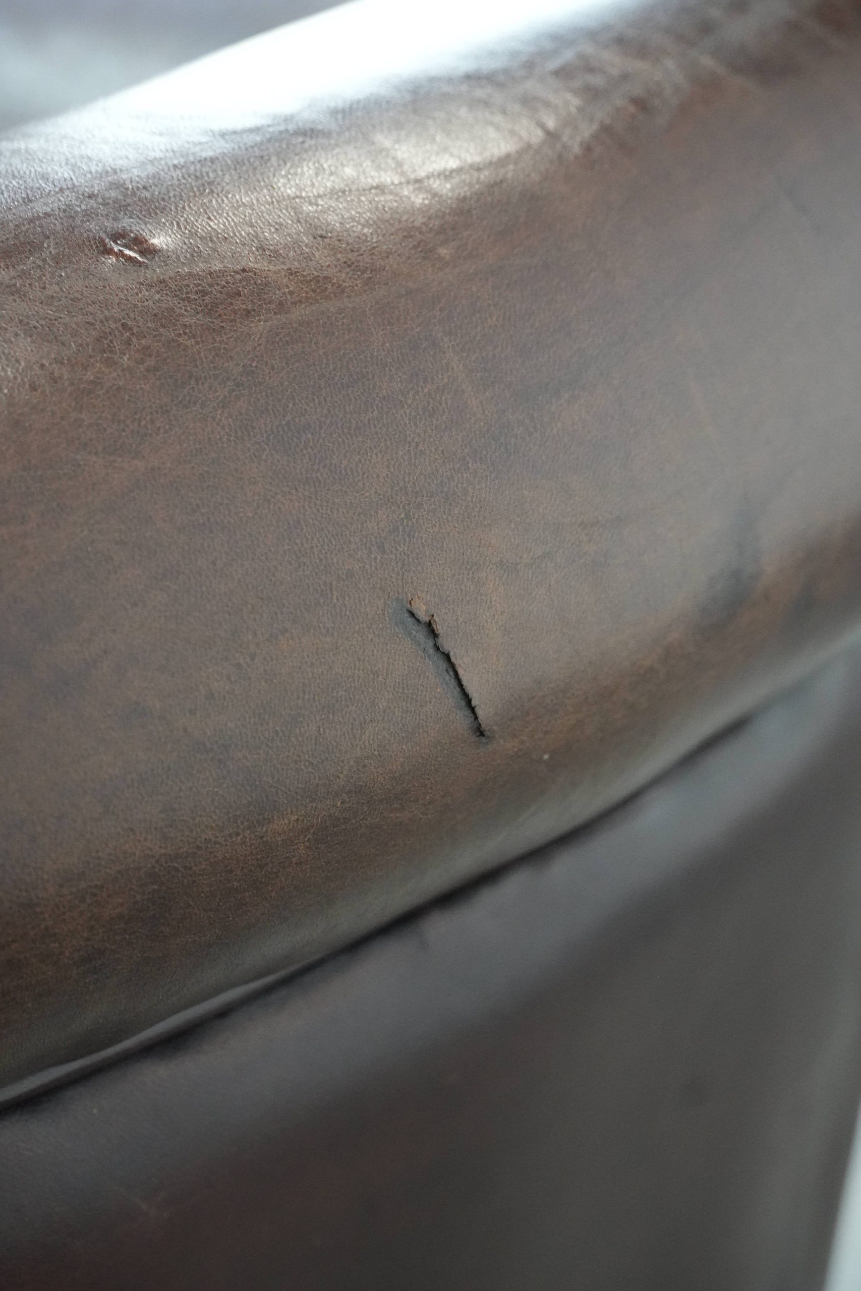 Stylish and sturdy dark brown club armchair made of sheepskin leather