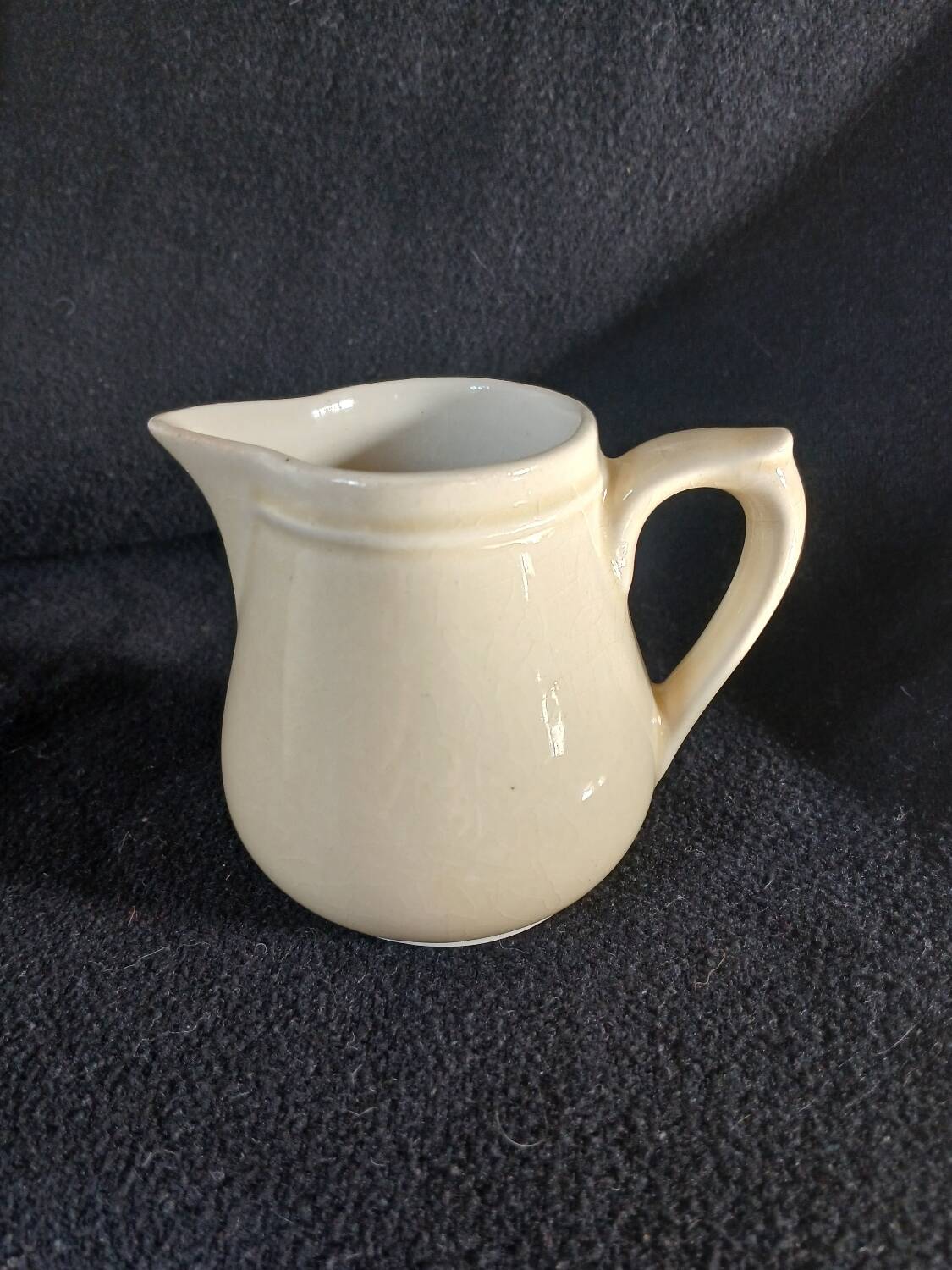 Old milk jug in steel clay