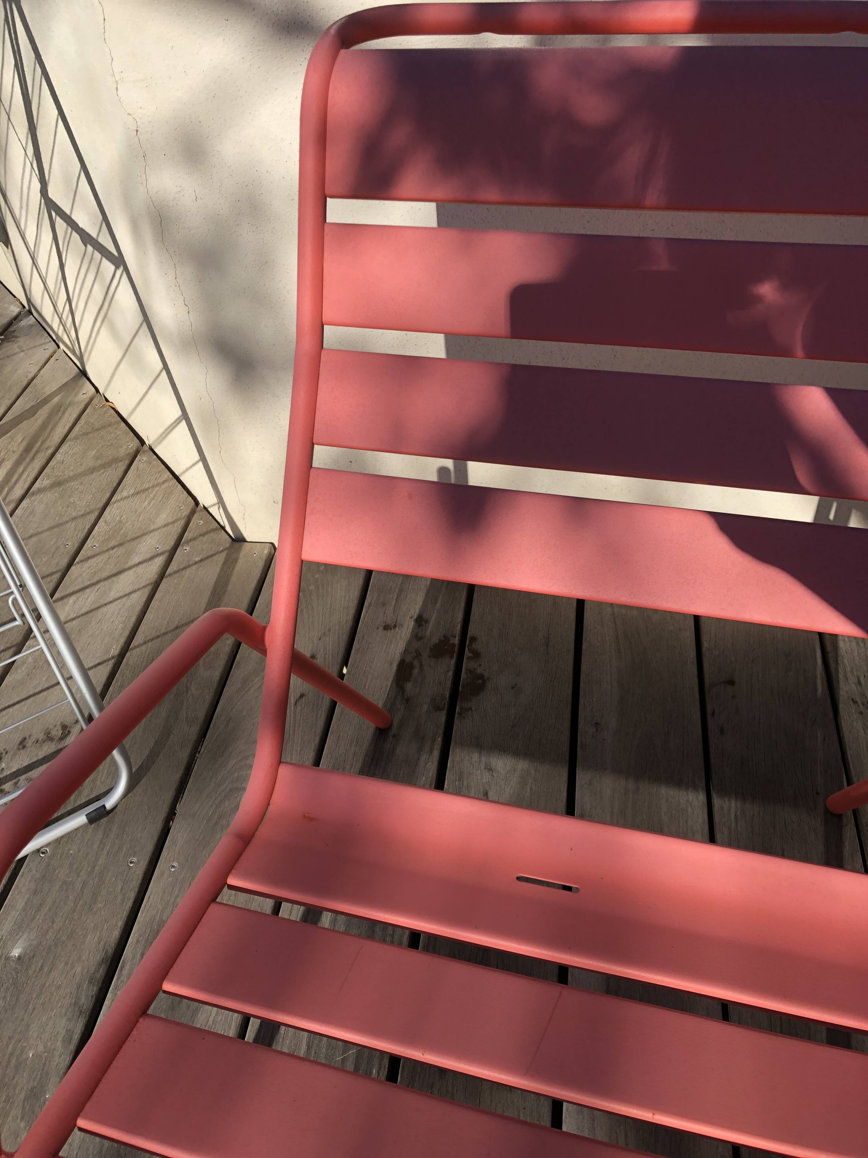2 low chairs Fermob model Monceau in capucine colour.