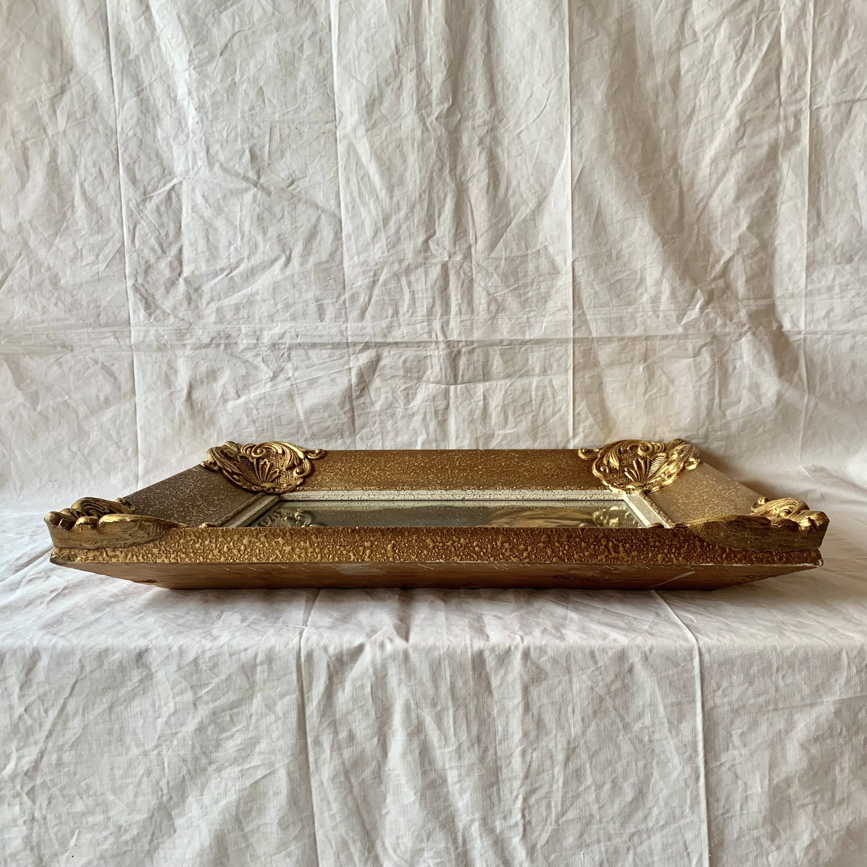 Old wall frame in carved gilded wood