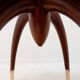 Round Art Deco side table in wood with curved legs and brass feet.