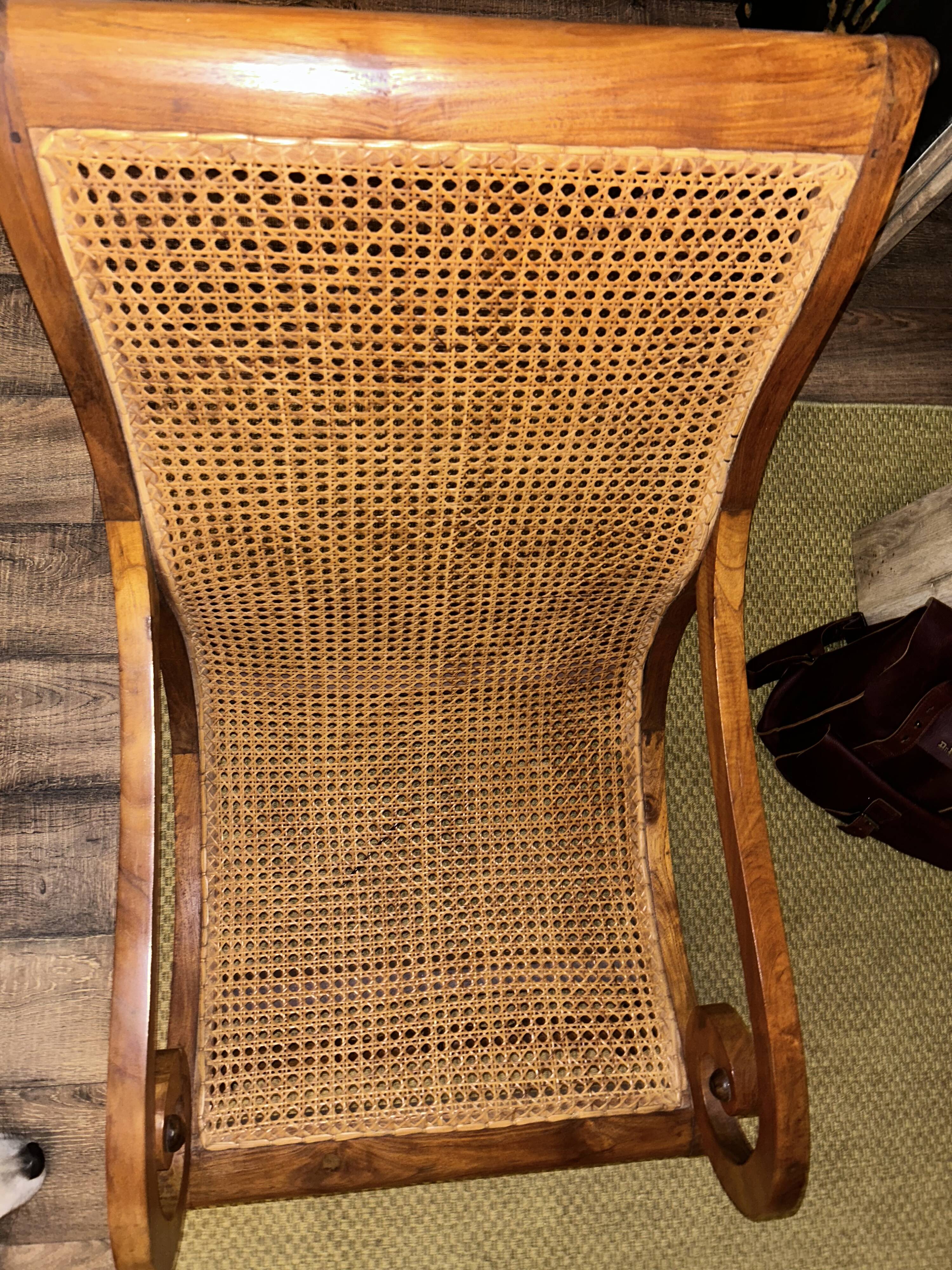 Colonial planter's armchair in solid teak, scroll armrests, caned seat.