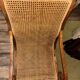 Colonial planter's armchair in solid teak, scroll armrests, caned seat.