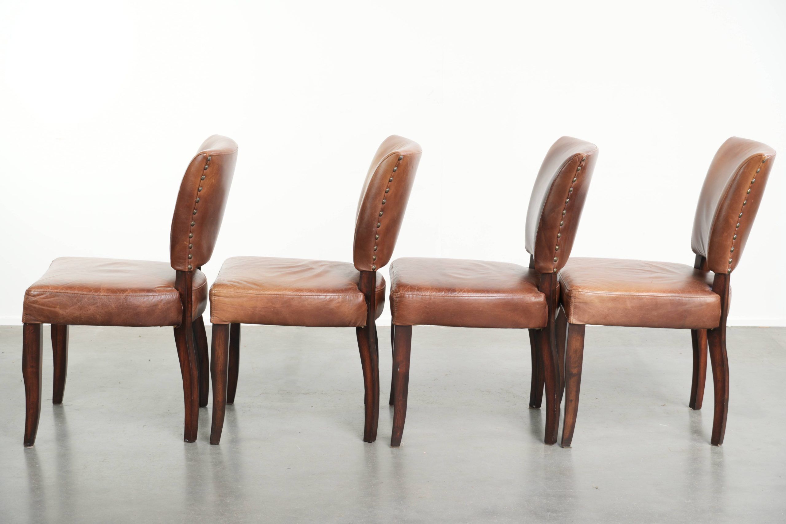 Set of 4 cognac-coloured cowleather dining chairs with decorative nails