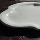 Antique oval-shaped white crackled faience plate with a scalloped edge.