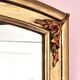 Art Deco mirror in gilded wood with curved floral decorations.
