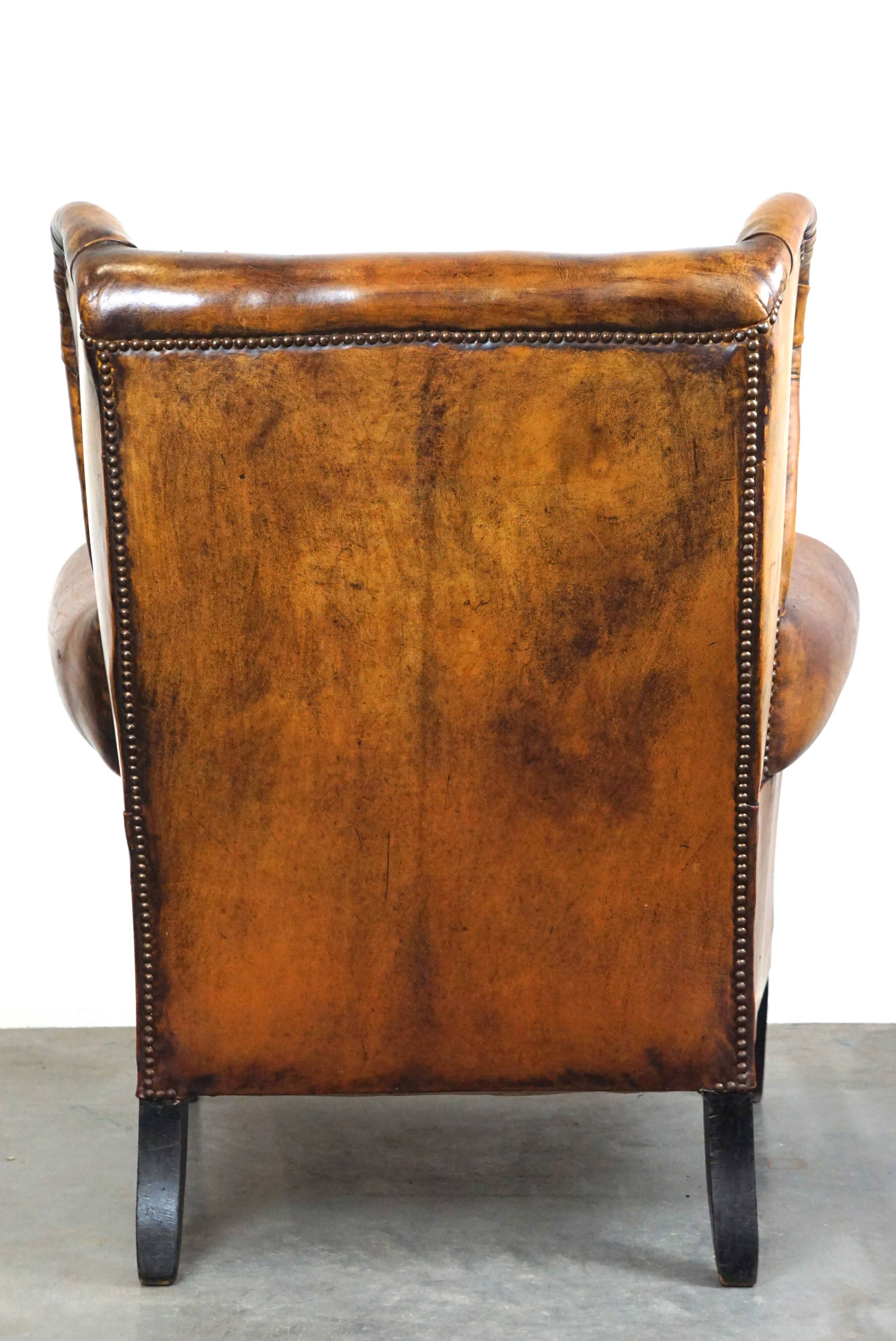 Irresistible old sheep leather wingback armchair with the most beautiful colors
