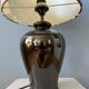Small Space Age table lamp with a porcelain base and black and white flower shade.