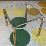 Pair of small nesting coffee tables in gold tubular metal & transparent glass tops